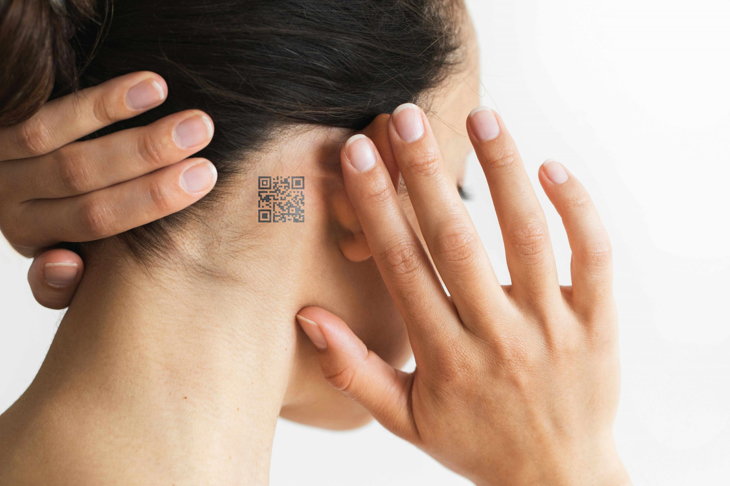 A photo of a woman with a QR Code on her neck.
