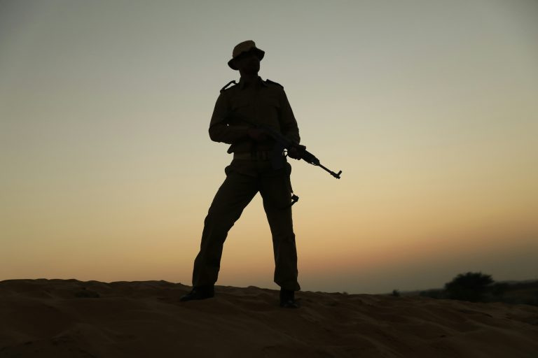 The silhouette of a modern soldier on sunset.